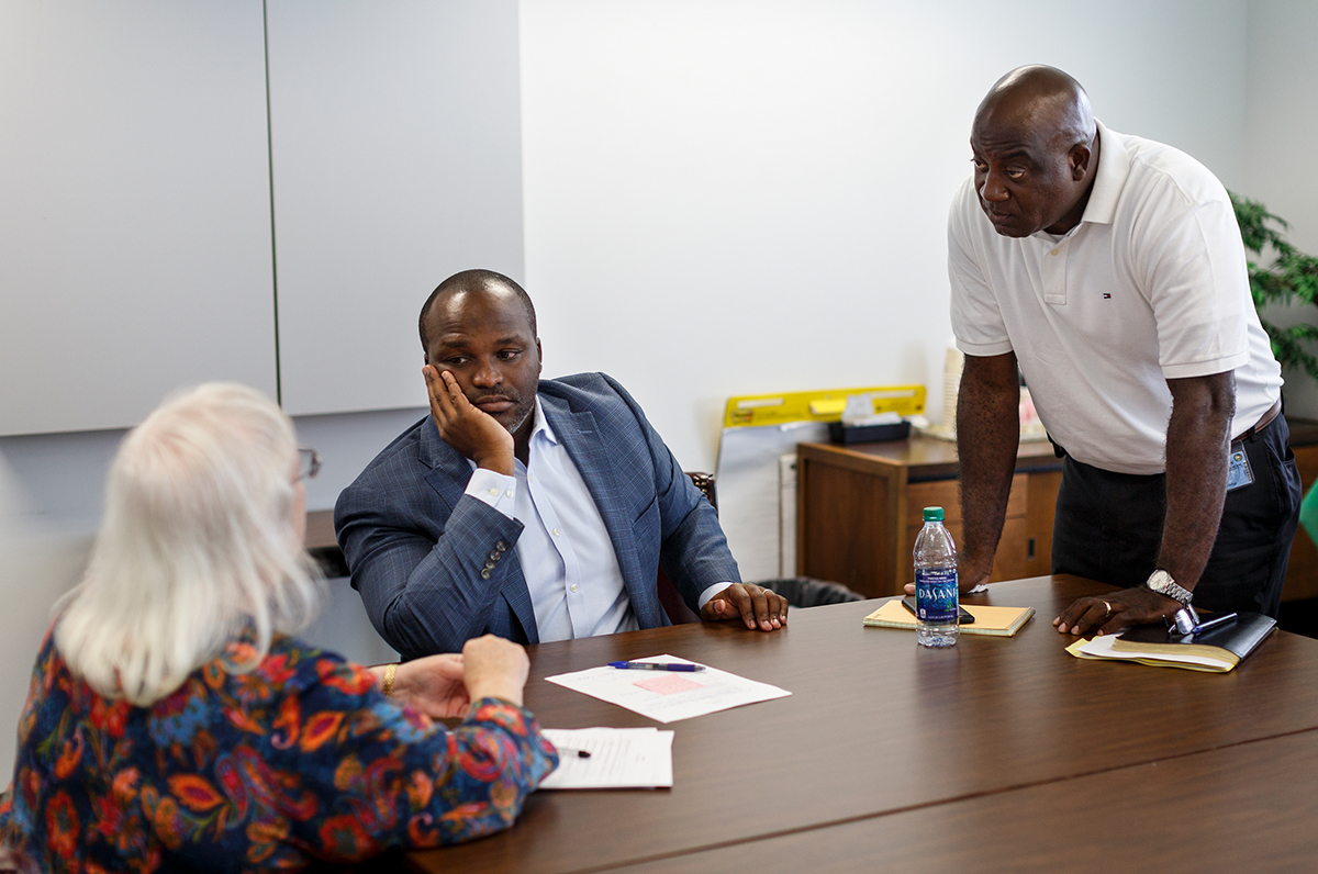 Hamilton County Schools Superintendent Bryan Johnson talks with new COO Kenneth Bradshaw, right, and Christie Jordan after a meeting at the central office building on Thursday, July 12, 2018, in Chattanooga, Tenn. Johnson is wrapping up his first year as superintendent.