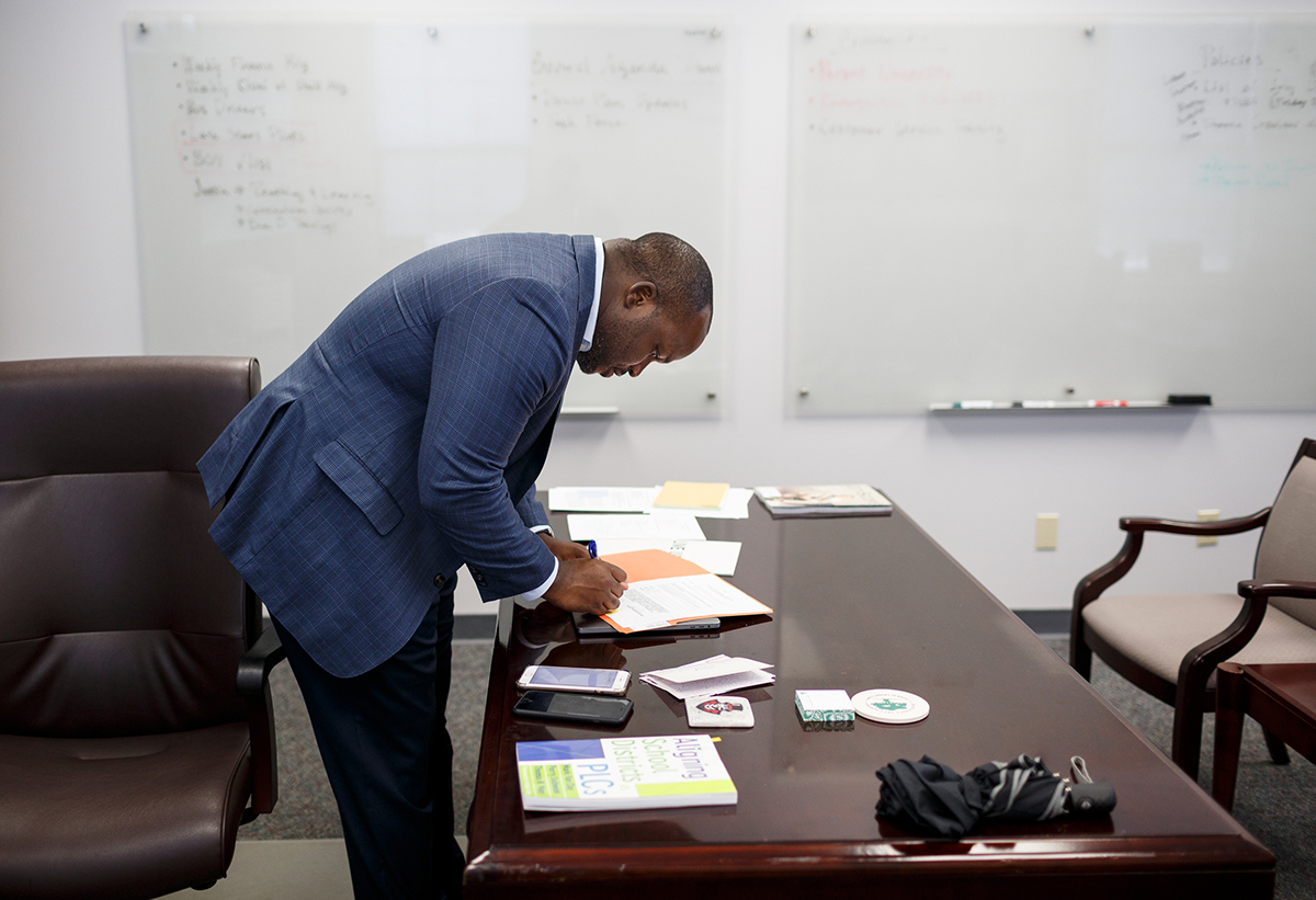 Hamilton County Schools Superintendent Bryan Johnson signs paperwork in his office at the central office building on Thursday, July 12, 2018, in Chattanooga, Tenn. Johnson is wrapping up his first year as superintendent.
