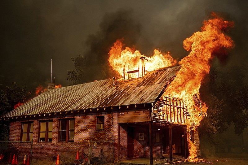 An historic schoolhouse burns as the Carr Fire tears through Shasta, Calif., Thursday, July 26, 2018. Fueled by high temperatures, wind and low humidity, the blaze destroyed multiple homes and at least one historic building. (AP Photo/Noah Berger)