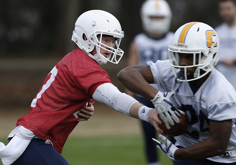 UTC running back Alex Trotter takes a handoff from Chris James during spring practice. The former McCallie standout enters his senior season as the most experienced returning running back on the roster.
