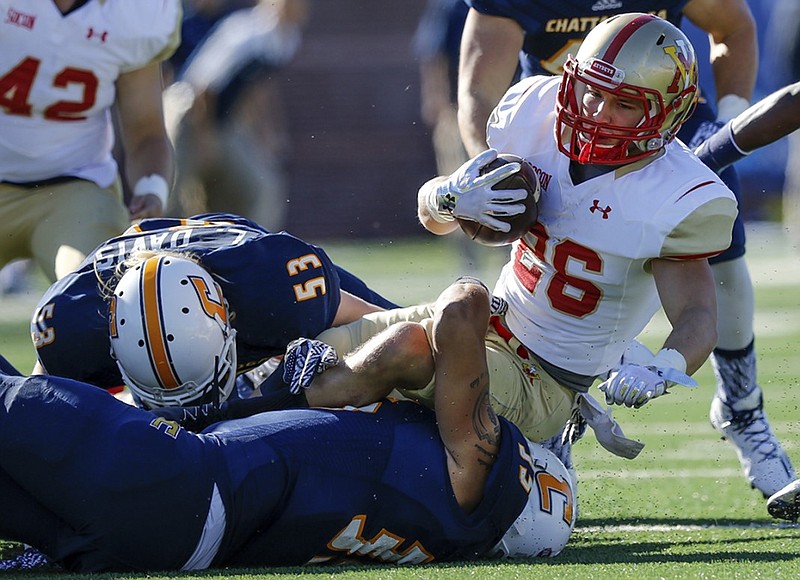 UTC linebackers Michael Bean, bottom, and Luke Davis tackle VMI wide receiver Mason Dermott during a game at Finley Stadium in October 2016. Dermott is entering his senior season with the Keydets.