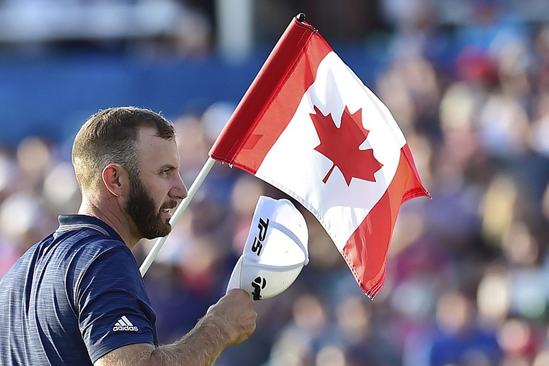 American golfer Dustin Johnson, No. 1 in the world, salutes the crowd on the 18th hole at Glen Abbey Golf Club after winning the RBC Canadian Open on Sunday in Oakville, Ontario.