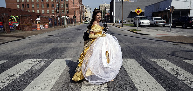 Dressed as Princess Beauty, Kandace Shipley crosses a downtown intersection while on her way to an event. 