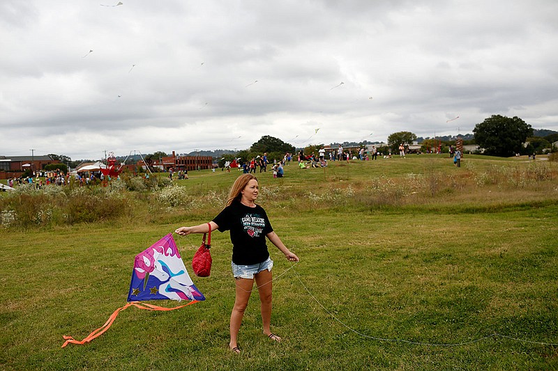 Pam Broom holds a kite and waits for wind during the Sculptures in the Sky kite festival at the Sculpture Fields of Montague Park on Saturday, Oct. 7, 2017, in Chattanooga, Tenn. Kite-fliers from across the country arrived to set up elaborate kites for the event.