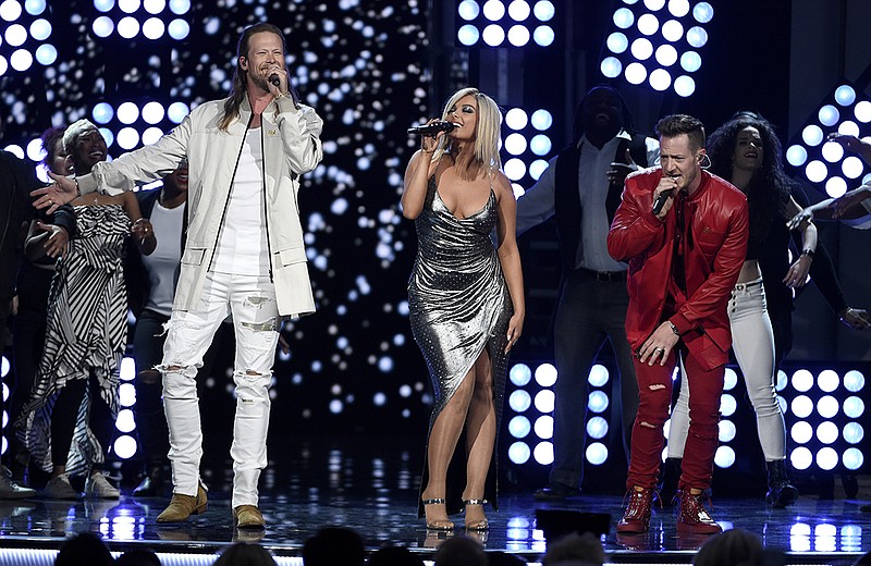FILE - In this April 15, 2018 file photo, Tyler Hubbard, right, and Brian Kelley, left, of Florida Georgia Line, and Bebe Rexha, center, perform "Meant to Be" at the 53rd annual Academy of Country Music Awards in Las Vegas. 