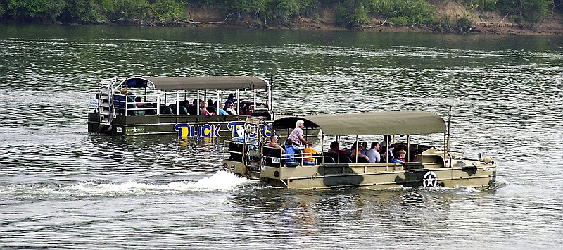 A pair of Chattanooga Duck Tour boats cruise along the Tennessee River.