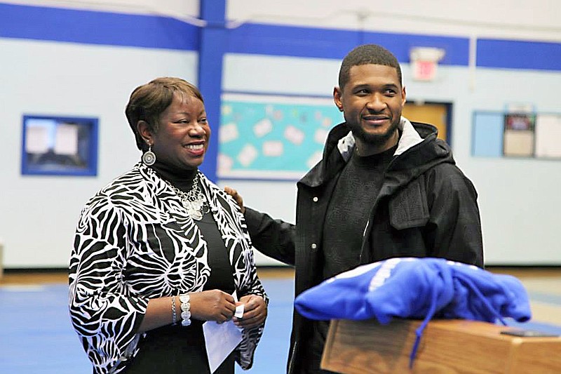 Edwards presents Usher with a certificate for his generosity to Dalewood Middle during a motivational speech he gave at the school in 2015. 