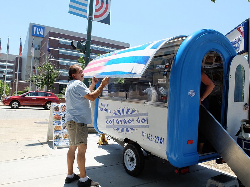 Go Gyros Go owner Frank Fotiadis closed up at 2 p.m. Monday after a day of brisk business across from the Pickle Barrel on Market Street. The City Council will be considering an ordinance that regulates food trucks. / Staff photo by Tim Barber
