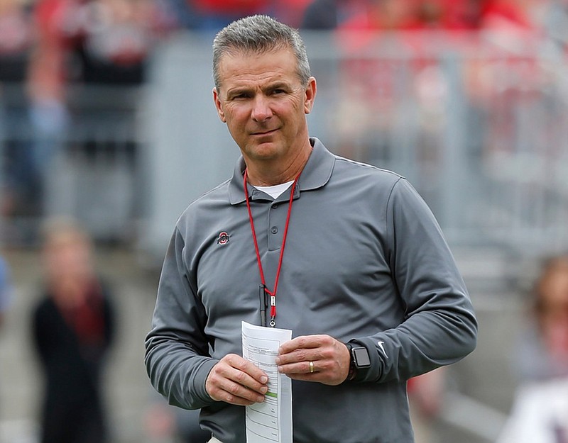 Ohio State football coach Urban Meyer watches the Buckeyes' spring game in April. Ohio State has placed Meyer on paid administrative leave while it investigates claims his wife knew about allegations of abuse against an assistant coach years before he was fired last week.