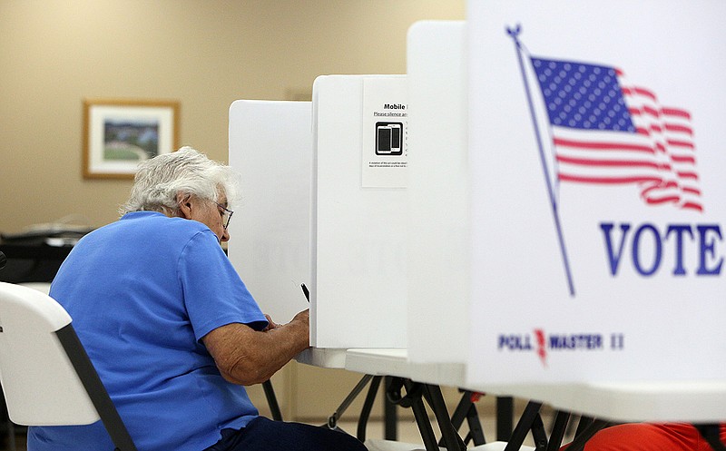 A woman fills out her ballot for the general election and state primary contests at the Hamilton County Election Commission during early voting last month.