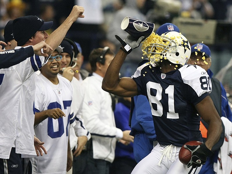 Terrell Owens throws popcorn in his face after scoring for the Dallas Cowboys in the second quarter of a November 2007 game against the Green Bay Packers. Owens, part of this year's enshrinement class for the Pro Football Hall of Fame, will give his induction speech Saturday afternoon at UTC, where he was a standout player from 1992 to 1995.