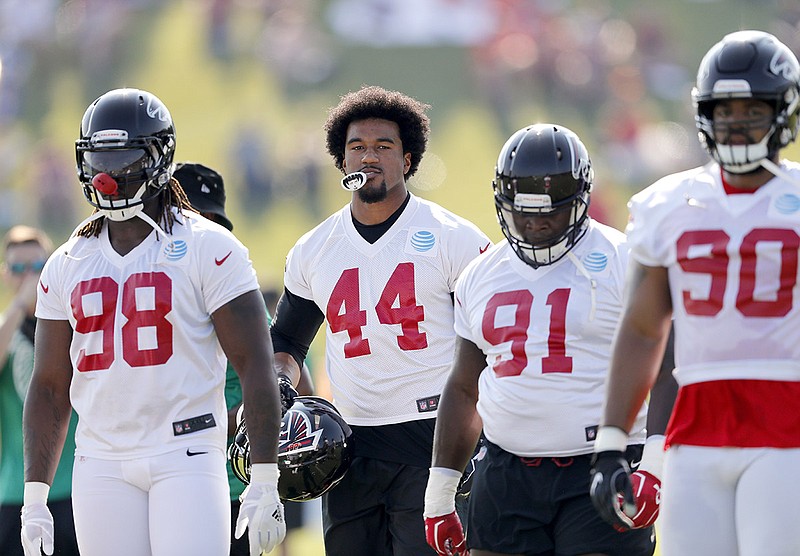 Vic Beasley (44) walks with Atlanta Falcons teammates during practice last week in Flowery Branch, Ga. After playing some at outside linebacker last year, Beasley is back at defensive end on a full-time basis entering his fourth NFL season.