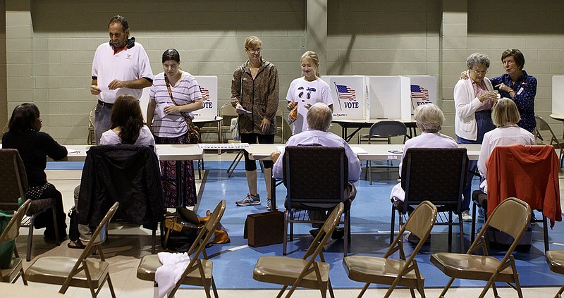 People check in with poll workers before voting on election day at Concord Baptist Church on Thursday, Aug. 2, 2018, in Chattanooga, Tenn.