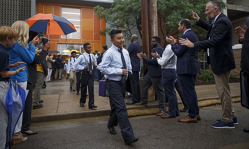 Staff photo by C.B. Schmelter / 
Christofer Diaz, center, and his fellow classmates are greeted as they walk outside on the first day of school on the Chattanooga Girls Leadership Academy/Chattanooga Preparatory School campus on Thursday, Aug. 2, 2018 in Chattanooga, Tenn.