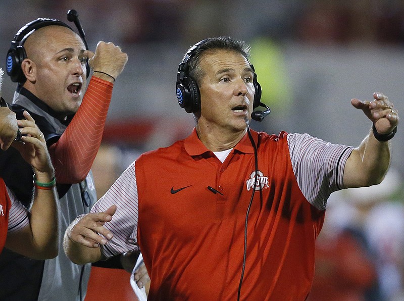 Ohio State football coach Urban Meyer, right, and assistant Zach Smith, left, gesture from the sideline during a game at Oklahoma in September 2016.