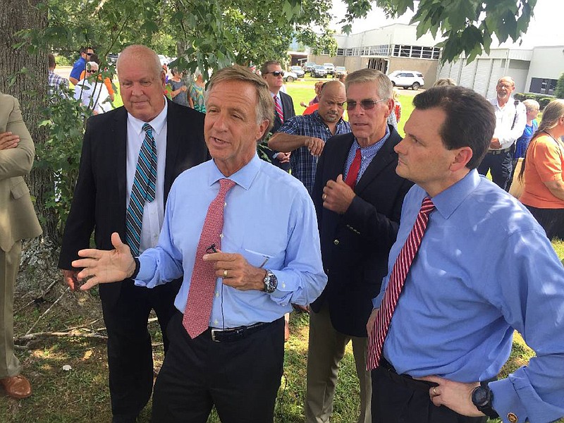 Tennessee Gov. Bill Haslam, center, talks in July 2017 about the $27.1 million investment a new textile company plannned in Pikeville to create 1,000 jobs. With Haslam, from left, are Pikeville Mayor Philip "Winky" Cagle, Bledsoe County Mayor Gregg Ridley and Troy King, chief legal counsel for Textile Corporation of America. Photo by Contributed Photo /Times Free Press.
