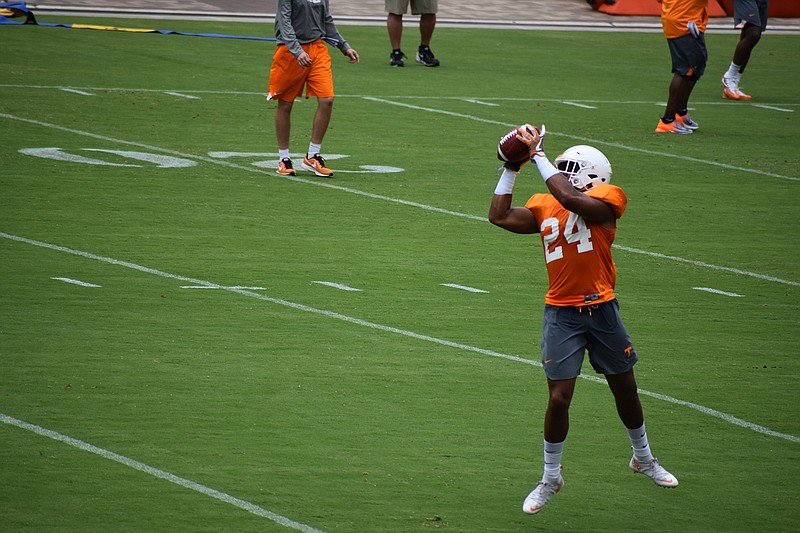 Tennessee redshirt senior defensive back Todd Kelly Jr. leaps for an interception as part of a drill during Tennessee's open practice at Neyland Stadium on Aug. 5, 2018.