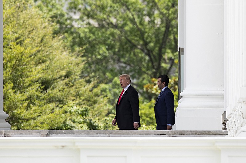 President Donald Trump with his son Donald Jr. leave the White House in Washington on their way to a political rally, July 5, 2018. Trump on Aug. 5 denied a report that he is worried about the legal exposure for his son, who hosted a June 2016 meeting between some of Trump's top campaign advisers and a Kremlin-connected lawyer. (Samuel Corum/The New York Times)