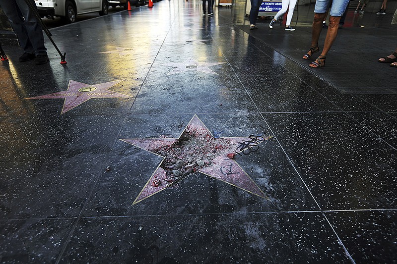 FILE - This July 25, 2018, file photo shows Donald Trump's vandalized star on the Hollywood Walk of Fame in Los Angeles. The West Hollywood City Council has unanimously approved a resolution seeking to remove President Donald Trump's star from the Hollywood Walk of Fame. The resolution urges the Hollywood Chamber of Commerce and Los Angeles to remove the star because of what it says is Trump's "disturbing treatment of women and other actions." (AP Photo/Reed Saxon, File)

