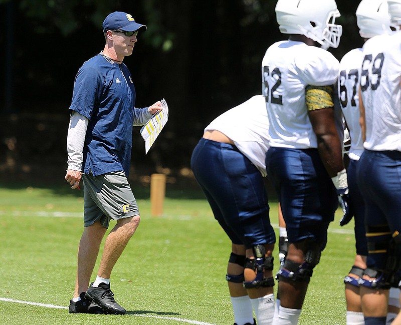 UTC wide receivers coach Greg Harbaugh talks to players during practice Monday. Harbaugh is in his first season on staff, with second-year head coach Tom Arth having hired him in the spring.