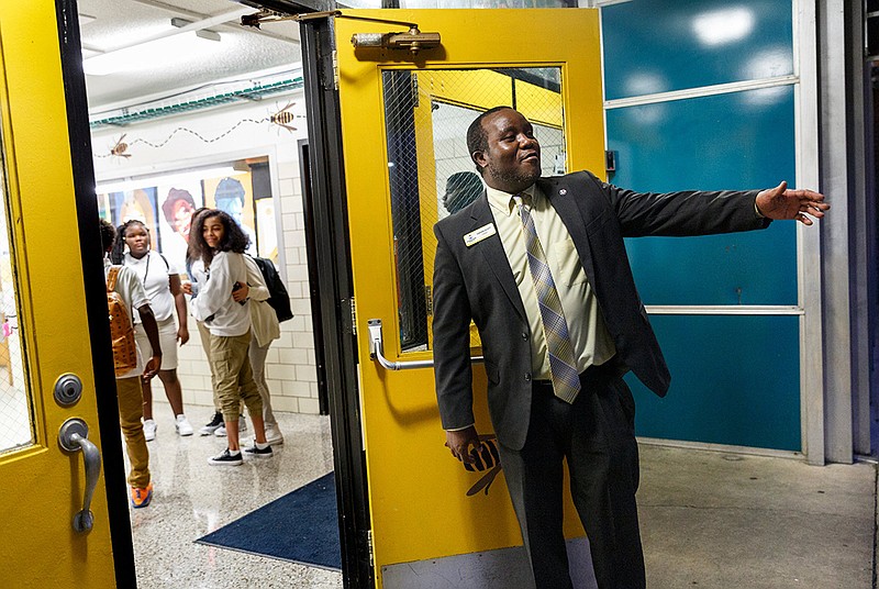 Orchard Knob Community PTA President Darian Scott greets students at Orchard Knob Middle School on the first day school in Hamilton County on Wednesday, Aug. 8, 2018, in Chattanooga, Tenn. The middle school invited community volunteers to help welcome students back to school.