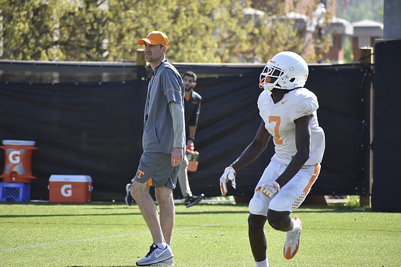 Tennessee receiver Brandon Johnson tracks the ball as offensive coordinator Tyson Helton looks on during a practice at Haslam Field in Knoxville this past April. Johnson has shown consistency in the early portion of this preseason.