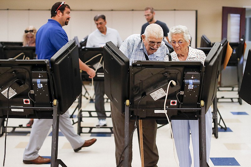 Voters cast their ballots among an array of electronic voting machines in a polling station at the Noor Islamic Cultural Center, Tuesday, Aug. 7, 2018, in Dublin, Ohio. Two-term state Sen. Troy Balderson, is fighting off a strong challenge from Democrat Danny O'Connor, a 31-year-old county official, in a congressional district held by the Republican Party for more than three decades. (AP Photo/John Minchillo)