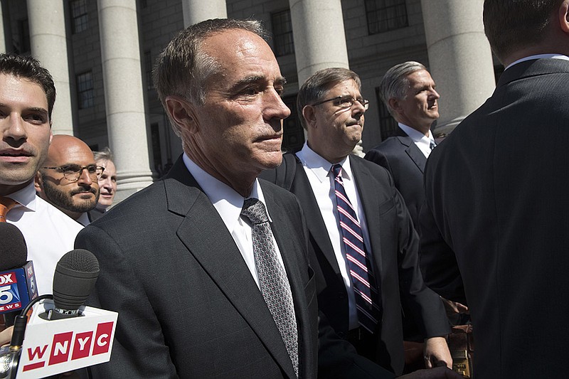 Republican U.S. Rep. Christopher Collins, center, leaves federal court, Wednesday, Aug. 8, 2018, in New York. 