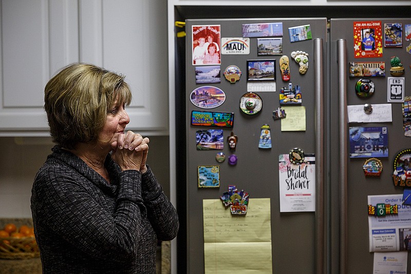 Mementos from Diana Parkinson's vacations with her husband Mark are displayed on the fridge as she talks about him at her home on Wednesday, March 7, 2018, in Rossville, Ga. Mark was shot through the window and killed by an unseen Walker County sheriff's deputy on the night of Jan. 1 after he walked into his kitchen with a handgun in response to his barking dogs, his wife says.