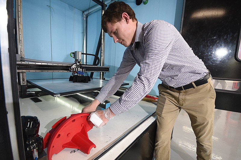 Staff photo by Tim Barber /
Mueller design engineer Aleksandr Migovich moves a model created by the Titan Atlas 3D printer under his control inside the new technology center on Chestnut Street.
