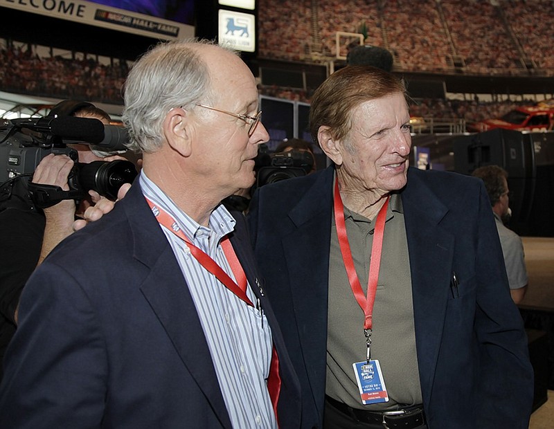 Former NASCAR team owner Bud Moore, right, is congratulated by Jim France, executive vice president of NASCAR, on Oct. 13, 2010, after being selected to the second class of inductees for the NASCAR Hall of Fame in Charlotte, N.C. France is now serving as interim chairman and CEO of NASCAR in the wake of his nephew Brian France's recent arrest on DWI and drug possession charges.