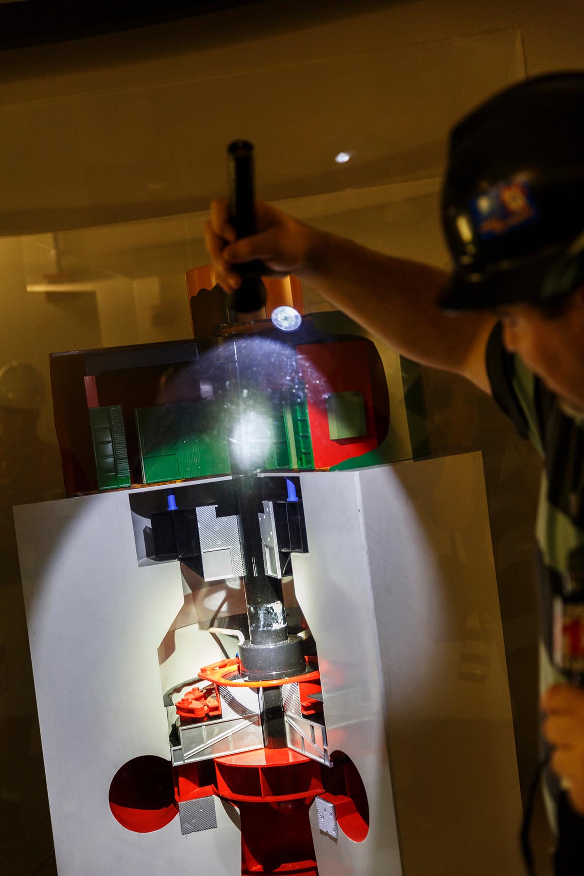 Plant manager Thomas Gamble shines a flashlight on a cross-section model of a generator that was used for the original tours inside TVA's Raccoon Mountain Pumped-Storage Plant on Friday, Aug. 10, 2018, in Chattanooga, Tenn. The hydroelectric facility halted tours for the public after the September 11 terrorist attacks in 2001, but they began offering tours again this year.