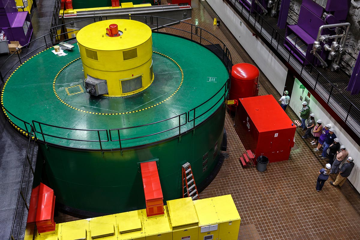 A group stands near a generator during a tour of the powerhouse floor in TVA's Raccoon Mountain Pumped-Storage Plant on Friday, Aug. 10, 2018, in Chattanooga, Tenn. The hydroelectric facility halted tours for the public after the September 11 terrorist attacks in 2001, but they began offering tours again this year.