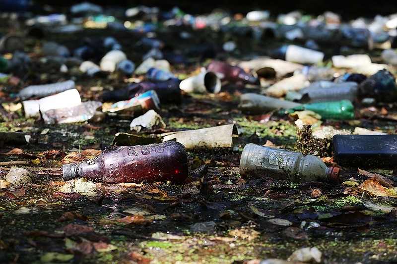 Staff photo by Erin O. Smith / 
A section of Chattanooga Creek is filled with plastic bottles and styrofoam cups Wednesday, August 8, 2018 in Chattanooga, Tennessee. The creek was nearly impassible at a few spots where trash and debris had created a dam of sorts.