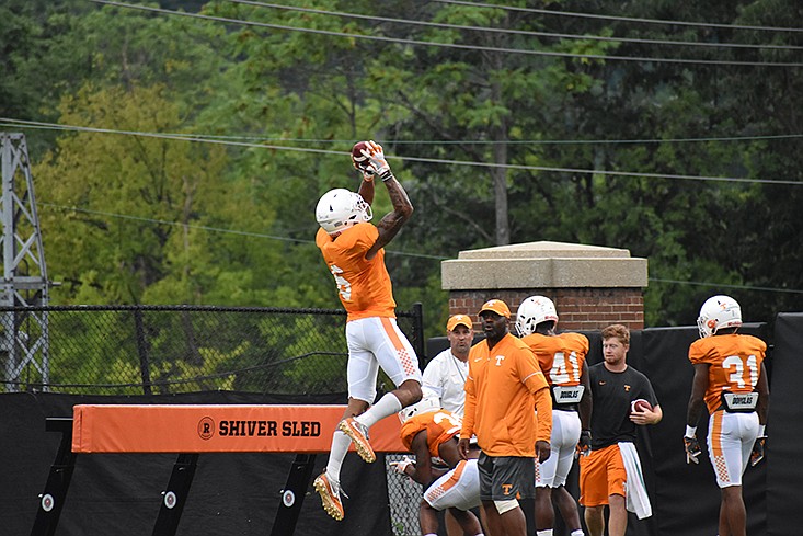 Freshman defensive back Alontae Taylor leaps for an interception during Tennessee's practice on Thursday in Knoxville.