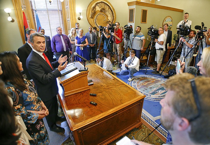 Kansas Gov. Jeff Colyer addresses the media on Wednesday, Aug. 8, 2018, at the Kansas Statehouse in Topeka, Kan. Out-of-power Kansas Democrats smelled opportunity Wednesday in the tight, unsettled GOP primary race for governor between Colyer and Secretary of State Kris Kobach, a close political ally of President Donald Trump and a conservative lightning rod who alienates even some Republicans. (Chris Neal/The Topeka Capital-Journal via AP)