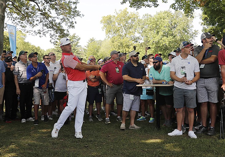 Gary Woodland makes his second shot on the 18th hole at Bellerive Country Club in St. Louis on Friday during the second round of the PGA Championship. Woodland shot a 66 and was at 10-under 130, breaking the tournament's 36-hole record by a stroke.