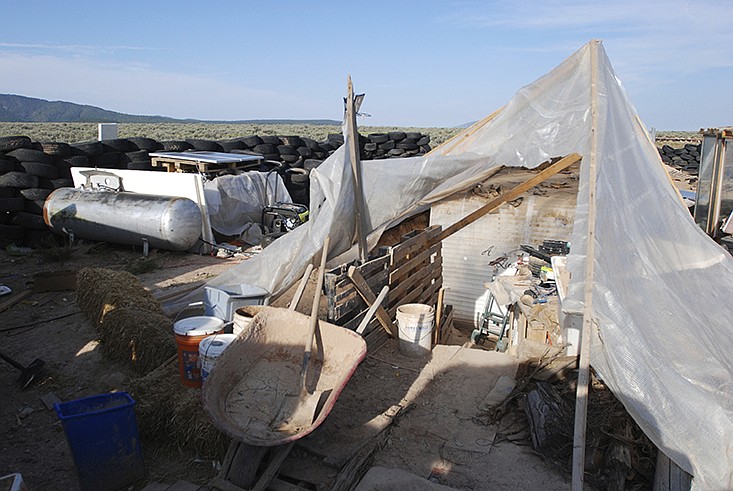 Various items litter a squalid makeshift living compound in Amalia, N.M., on Friday, Aug. 10, 2018, where five adults were arrested on child abuse charges and remains of a boy were found. 