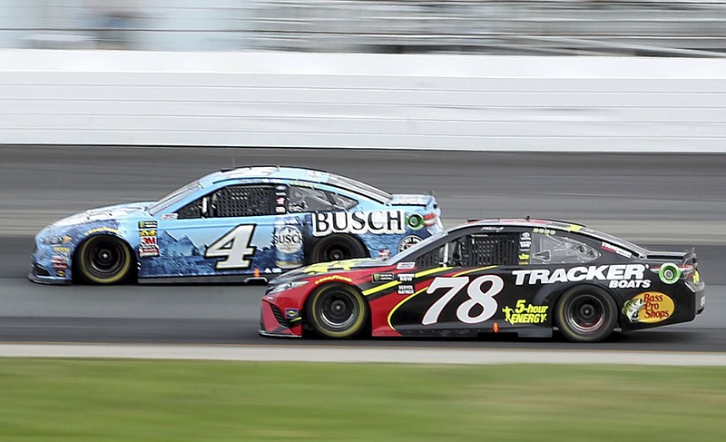 Kevin Harvick (4) and Martin Truex Jr. (78) race through the track's first turn during last month's NASCAR Cup Series race at New Hampshire Motor Speedway.