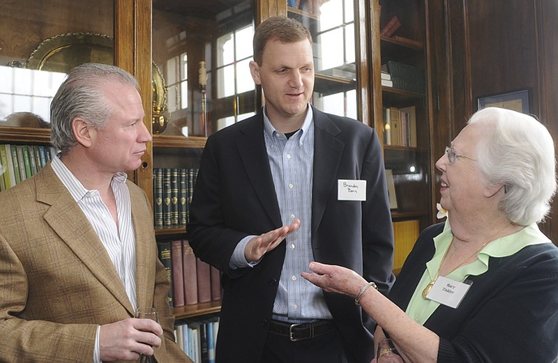 John Murphy, left, talks with Brandon Born, center, and Mary Tinkler during a reception at the University of Tennessee at Chattanooga to honor Murphy and his wife, Renee Haugerud in February 2009. The couple contributed $2 million to the university to be used to create a global finance center and help the football program.
Writer: 	 