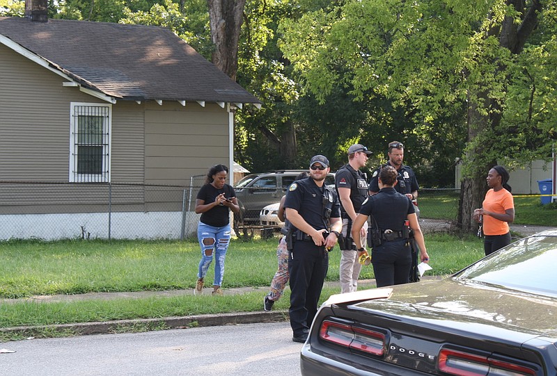 Chattanooga Police Department officers stand Saturday afternoon at the scene of a shooting that sent a man to the hospital with injuries deemed not life-threatening.