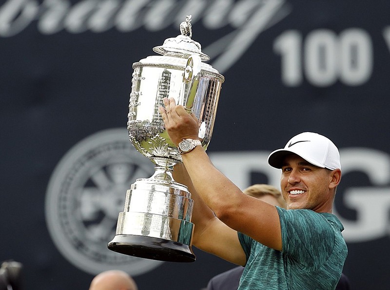 Brooks Koepka shows off the Wanamaker Trophy after winning the PGA Championship on Sunday at Bellerive Country Club in St. Louis.
