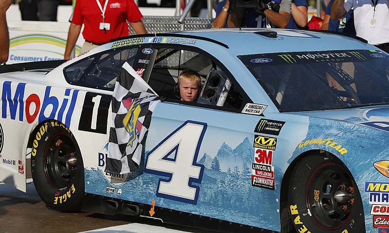 NASCAR driver Kevin Harvick's son, Keelan, rides with his father into victory lane at Michigan International Speedway. Harvick cruised to his seventh Cup Series win of the season Sunday.