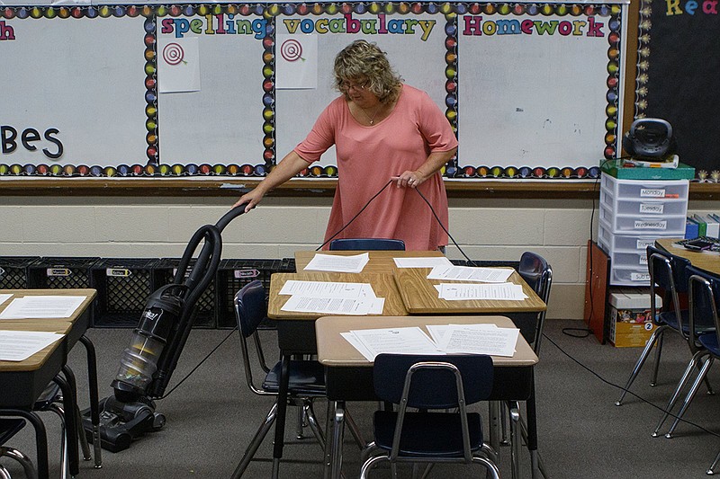 Third grade teacher Julie Warren vacuums her classroom at Hixson Elementary School on Tuesday, Aug. 7, 2018 in Hixson, Tenn.