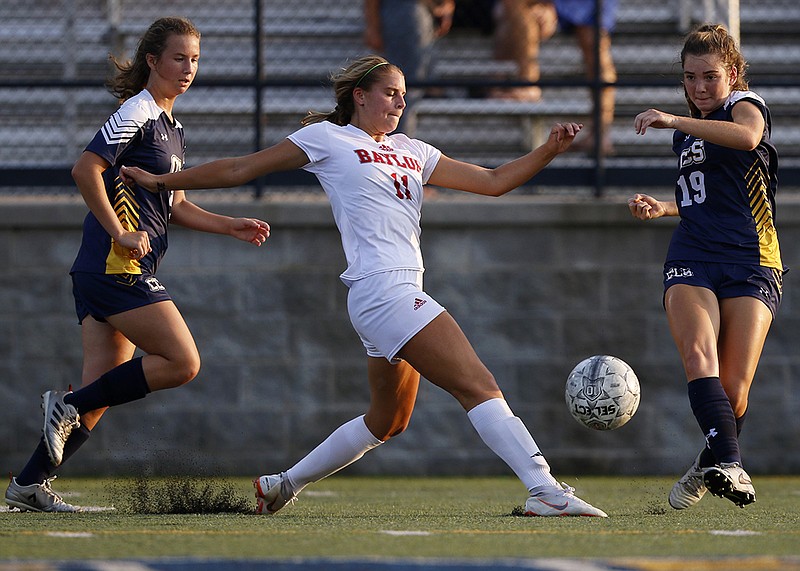 Staff photo by C.B. Schmelter / 
As teammate Katie Davick, left, chases Baylor's Avery Davis, center, Chattanooga Christian's Ellie Montgomery clears the ball away from Davis during their match at David Stanton Field on the campus of CCS on Tuesday, Aug. 14, 2018 in Chattanooga, Tenn.