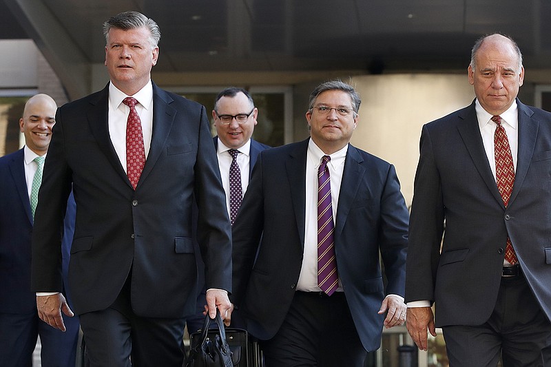 Members of the defense team for Paul Manafort, including from left, Jay Nanavati, Kevin Downing, Brian Ketcham, Richard Westling, and Thomas Zehnle, walk to federal court as the trial of the former Trump campaign chairman continues, in Alexandria, Va., Tuesday, Aug. 14, 2018. The focus in Paul Manafort's fraud trial shifts to the defense after prosecutors rested their case. (AP Photo/Jacquelyn Martin)