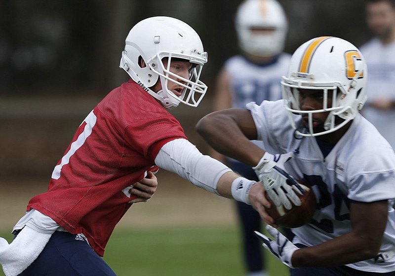 UTC senior running back Alex Trotter takes a handoff from Chris James during spring practice. Trotter, a former McCallie standout, is excited to be healthy entering his senior season.