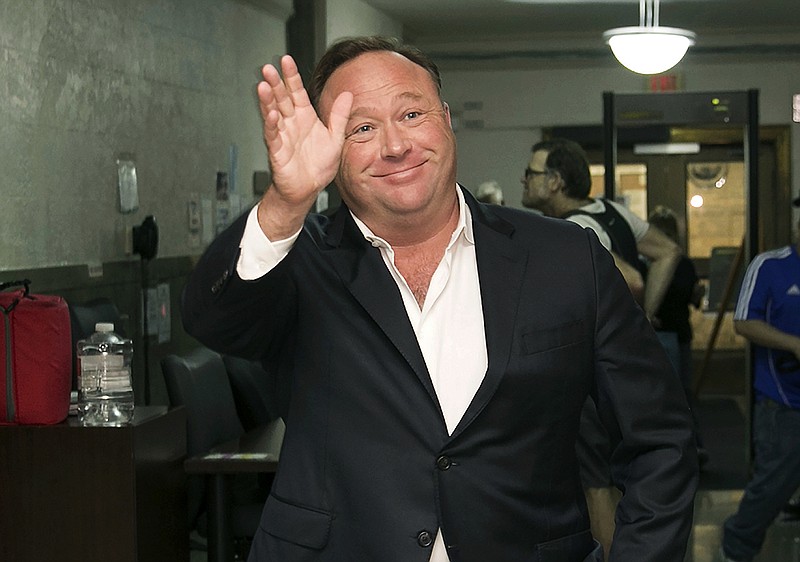 FILE - In this April 19, 2017, file photo, Alex Jones, a right-wing radio host and conspiracy theorist, arrives at the courthouse in Austin, Texas. 