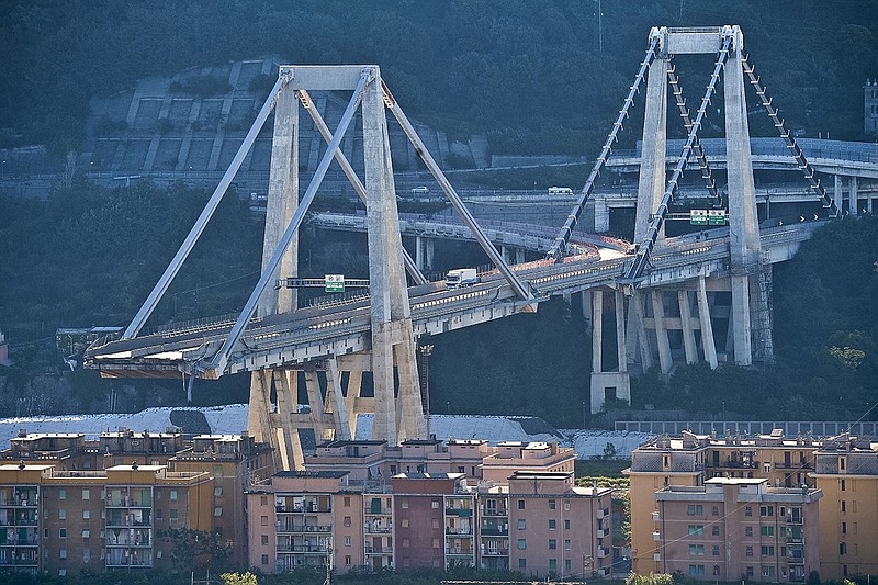 General view of the collapsed Morandi highway bridge in Genoa, northern Italy, Wednesday, Aug. 15, 2018. A bridge on a main highway linking Italy with France collapsed in the Italian port city of Genoa during a sudden, violent storm, sending vehicles plunging 90 meters (nearly 300 feet) into a heap of rubble below. (Luca Zennaro/ANSA via AP)