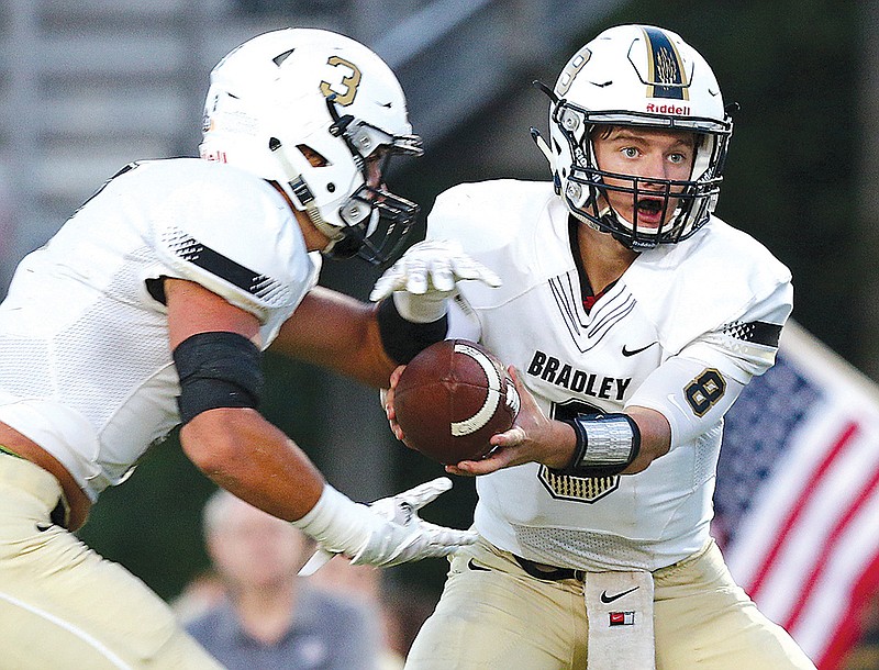 Bradley Central quarterback Dylan Standifer (8) hands the ball off to Nick Howell (3) during the Bradley Central vs. Walker Valley football game Friday, Aug. 25, 2017, at Walker Valley High School in Cleveland, Tenn. 